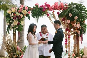 Bride and Groom in Formal Wear Marry Under Colorful Ceremony Arch, Tropical Flowers in Hawaii