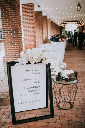 Formal Sign with Black Typography and White Flower Arrangement