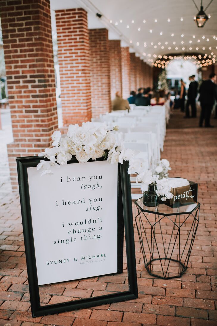 Formal Sign with Black Typography and White Flower Arrangement