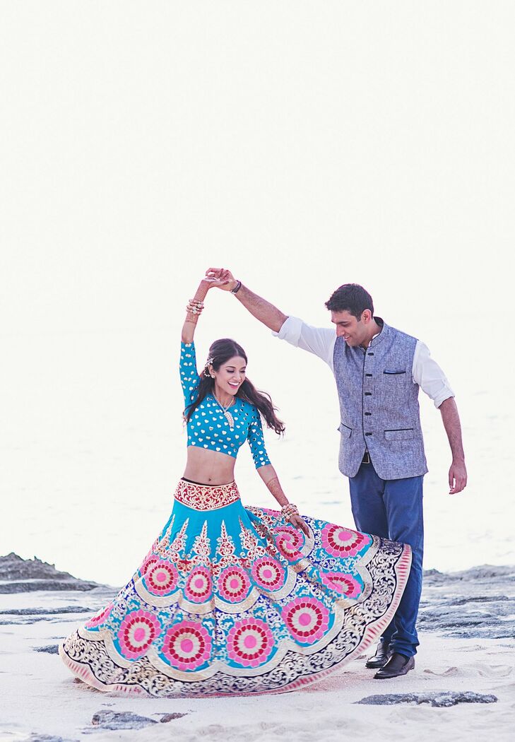 Melanie wore a dramatic blue and pink lehenga from Manish Arora for the mehndi party on the first night of their celebration. The boho-chic theme came to life with colorful lanterns and hundreds of candles in a private villa at Amanyara resort in Turks and Caicos.