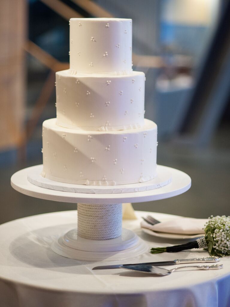 simple white three tier wedding cake with swiss dot decorations