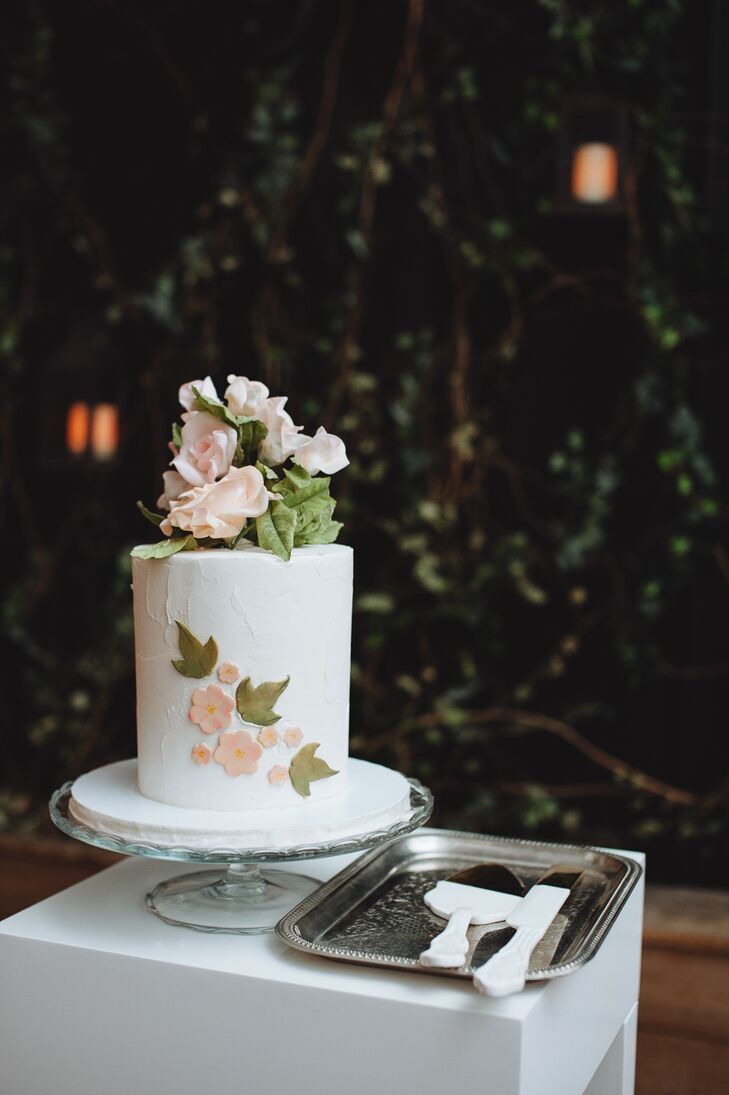 After a traditional sit-down dinner, Whitney and Ryan cut into their petite wedding cake. The one-tier confection featured stucco-style buttercream in a classic shade of white and pale pink fondant flowers. With Whitney’s preference for blush roses in mind, the pros at Lael Cakes topped the cake with a fresh bundle of the blooms.