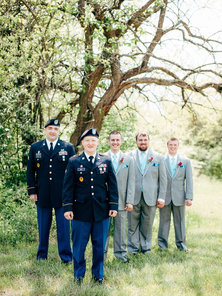 The groom donned his military uniform as did a groomsmen in the wedding party, but his other  attendants wore gray suits with blue accessories and accented them with bright red boutonnieres.