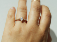 Marquise diamond center stone with round and rose cut diamonds on gold band
