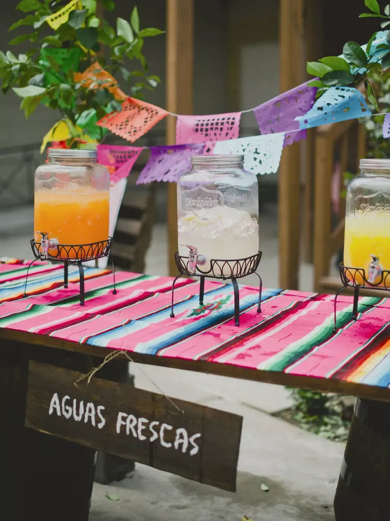 Colorful agua fresca drink table for signature wedding drink idea