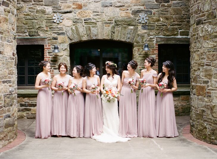 Spring was in the air at Alice and Stephen’s country soiree, with a palette of playful pastels and punchy yellow, orange and coral hues bringing the beauty of the season to life. For the bridesmaid attire, Alice had her ladies don floor-length chiffon gowns in a soft shade of mauve from J.Crew. Wanting them to show off some of their personalities, while adding visual intrigue to the overall look, she let them choose the necklines they liked best.