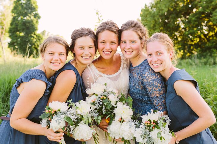 All the bridesmaids made sure to match with a blue color scheme, but in entirely different styles. One bridesmaid wore a lace, quarter-sleeve dress, while the others maintained a shorter sleeve without lace.