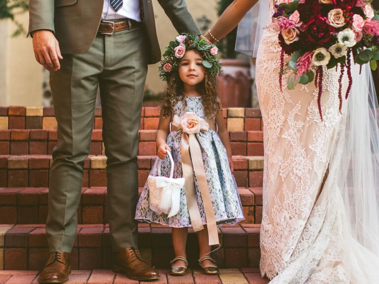 Flower girl wears her hair in loose curls with a flower crown. 