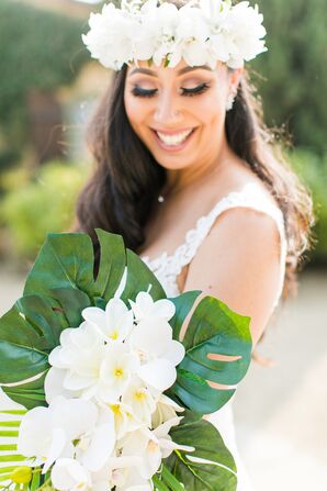 Bride Holding Tropical Bouquet with Plumeria and Monstera Leaves