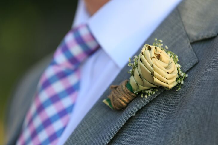Ben and the groomsmen wore their own gray suits for the wedding and wore blue, purple and blush checkered ties to match the wedding colors. They completed their look with a braided green-vine boutonniere accented with baby’s breath and tied with burlap.