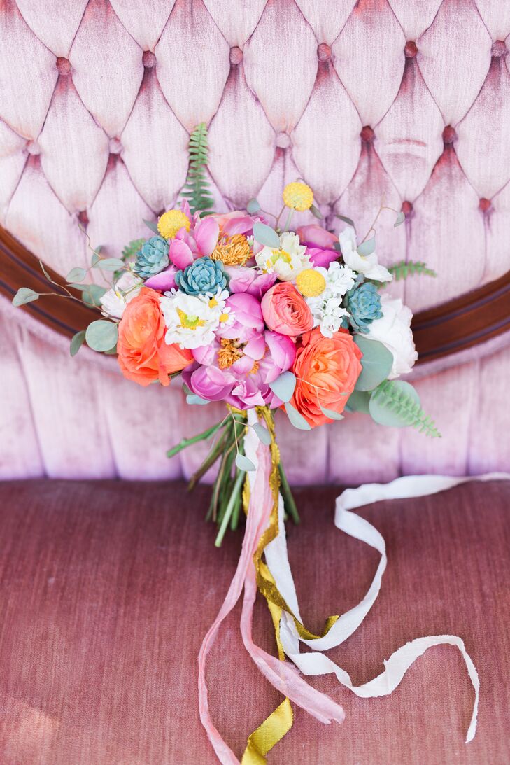 Mandy of MJM Designs created the arrangements, bouquets and flower crowns for the big day. "My only request was not to have any traditional roses," says Devin, who chose peonies, ranunculus and ferns. "Mandy really came through on executing my vision of fun and colorful."
