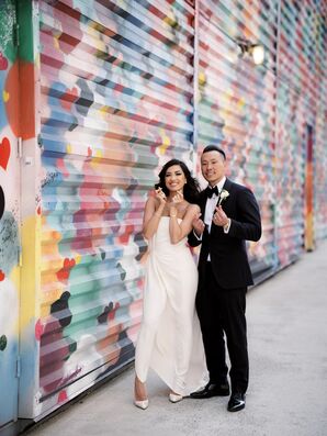 Bride and Groom Posing in Front of Wall Mural in New York