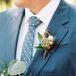 The groom's tie had tepees, arrows and campfires throughout the design. His boutonniere included a cord of leather.