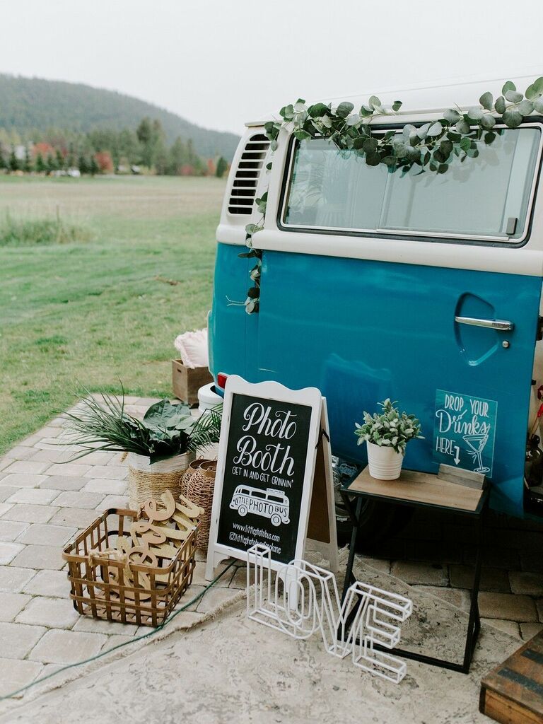 Blue VW bus with chalkboard sign and rustic decorations