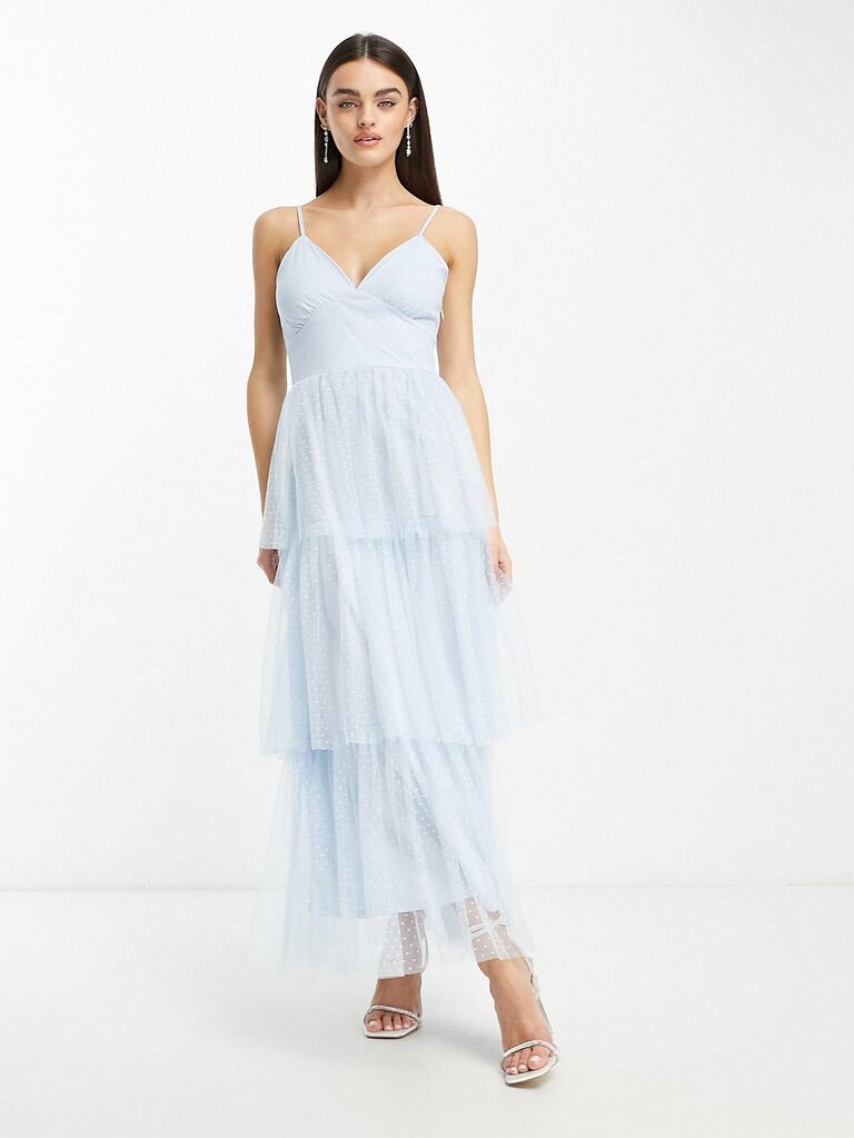 Model wears a ruffled sky-blue gown. 