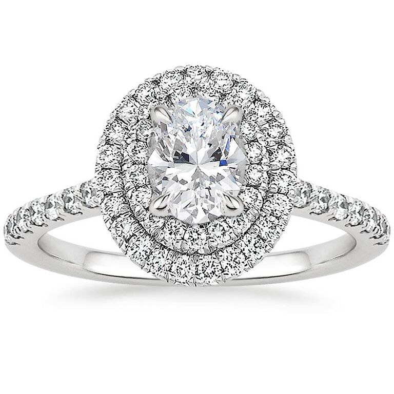 halo oval diamond engagement ring with scalloped pavé diamond band