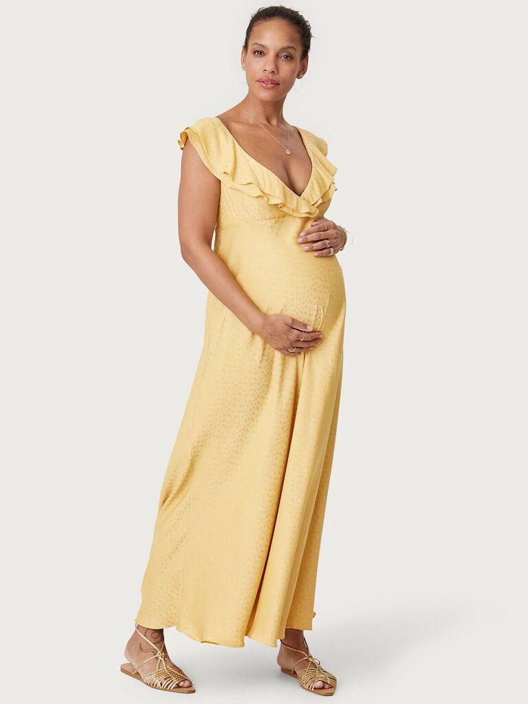 Hatch Collection cottagecore maternity wedding guest dress with a double-ruffled neckline and yellow floral print