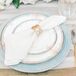 Elegant Place Setting with Patterned China and Gold Flatware