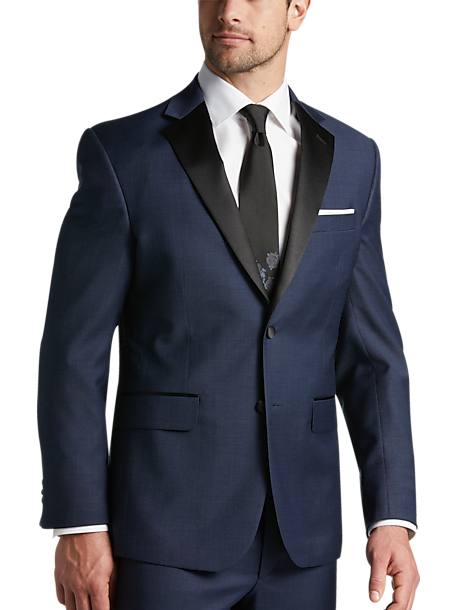 Model wears a navy blue suit for a garden wedding. 