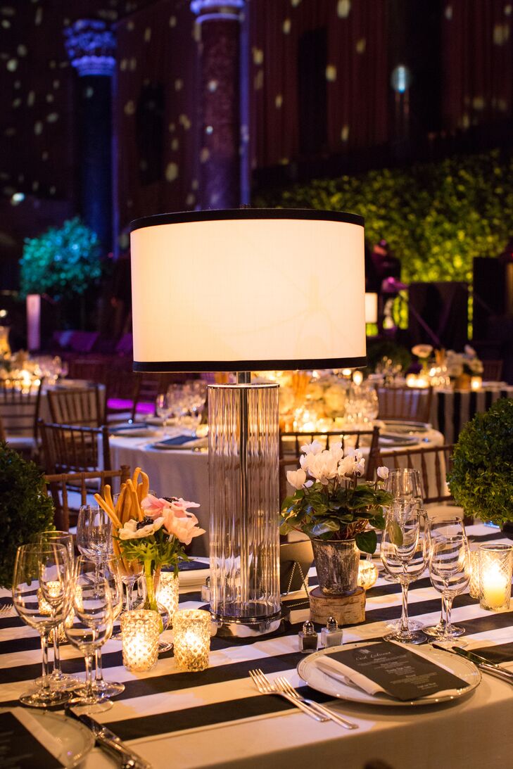 Several tables at the reception were topped with small floral arrangements, votive candles and glass table lamps, which made the space look “unique and more like an intimate dinner party meets supper club.”