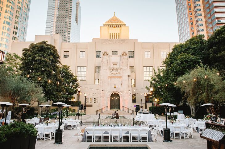 Adrienne and Cameron combined the contemporary setting of the reception with quaint floral arrangements and vintage lighting.