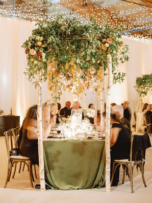 Guests Sitting at Table Under Rustic Canopy of Leaves and Aspen Branches