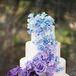 "Renowned cake baker Ana Parzych worked with us to design the most magnificent—and best tasting—cake our guests had ever seen, featuring handmade sugar flowers cascading down four tiers in an ombre theme of blues and purples," Lisa says. "Each tier had a different flavor combination, and each guest had the chance to taste all three."