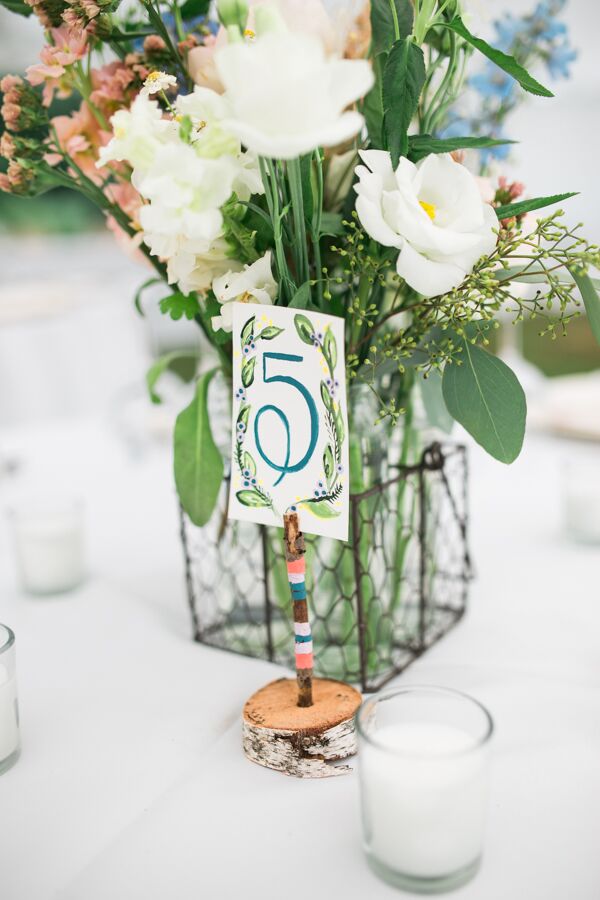 The couple opted for classic table numbers, but the design was anything but standard. Birch bases boasted color-blocked twigs and watercolor numbers decorated with painted garlands.