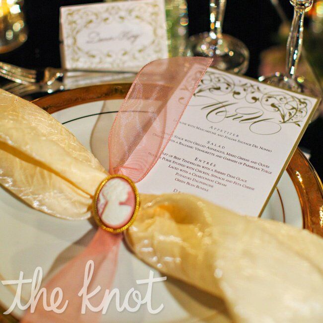 The gold napkins were tied with pink tulle and finished with cameos.