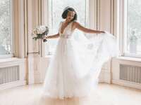 bride wearing a-line wedding dress holding bouquet