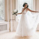 bride wearing a-line wedding dress holding bouquet