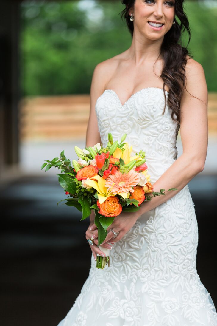 Early in their relationship, Brandon gave Kelsey a bouquet of circus roses. She's loved them ever since, so she knew she wanted them in her bouquet. Carol Lynn Events also included lilies,