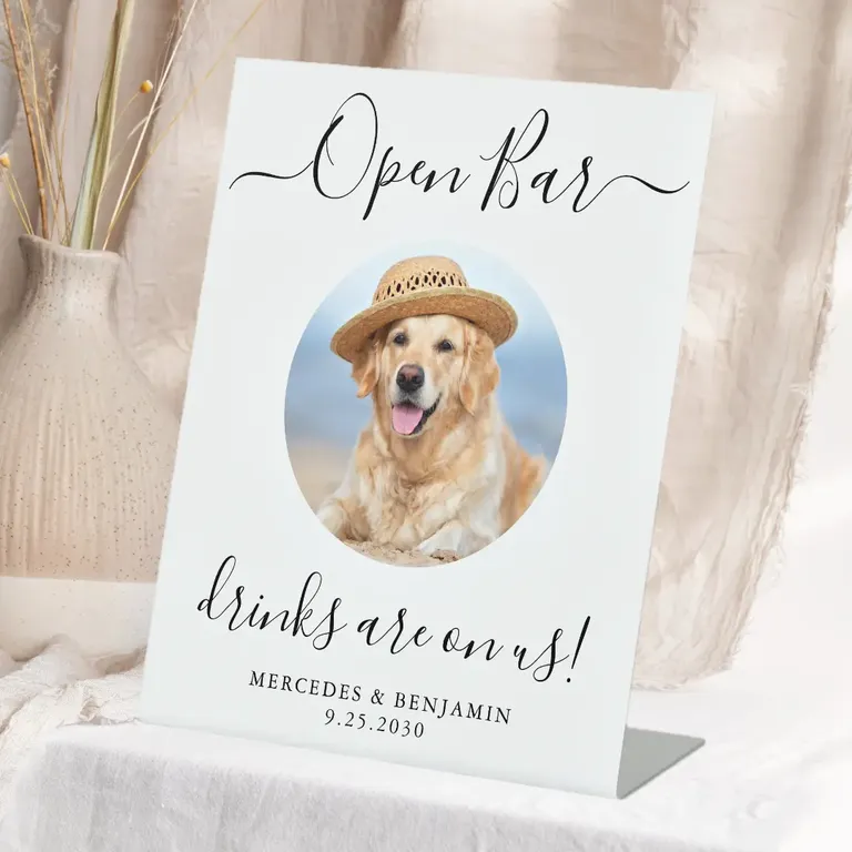 White open bar sign with black lettering and image of dog wearing a hat for wedding