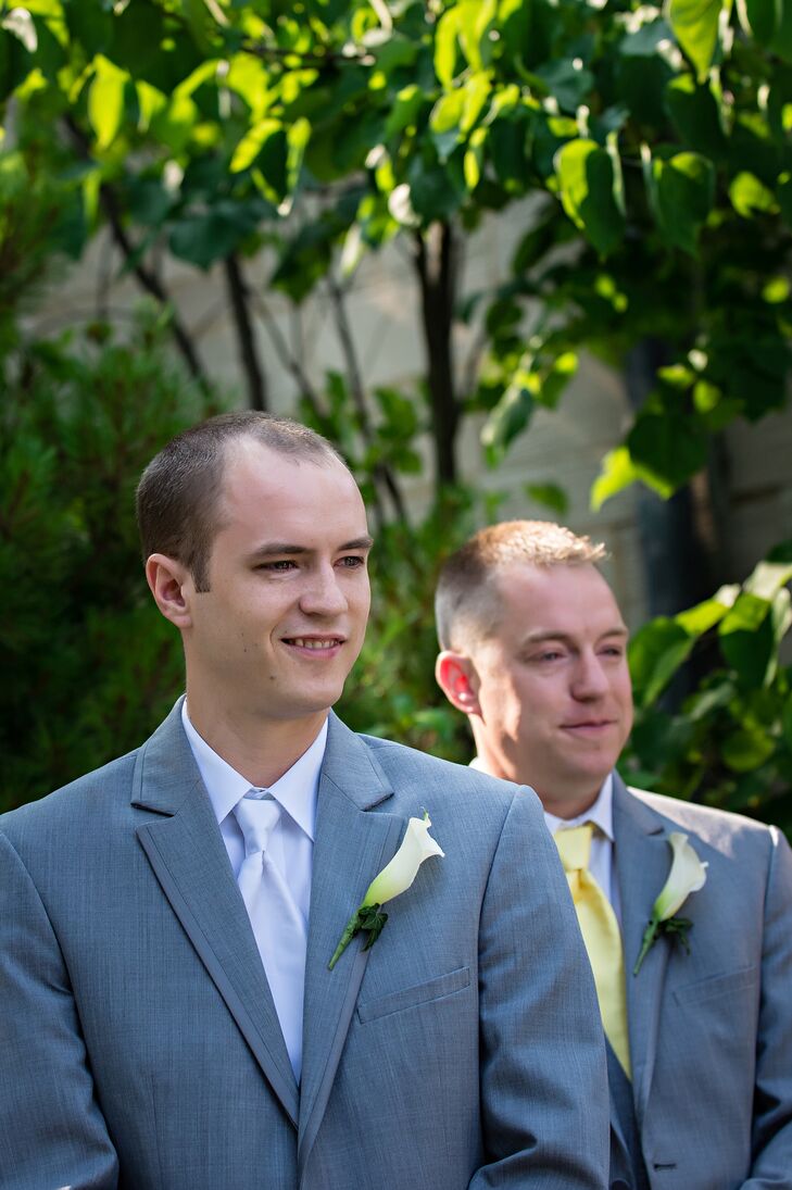 Jeremy and his groomsmen wore matching light gray suits with traditional ties--white for the groom, and pale yellow for the groomsmen. They each wore a single calla lily stem as a sleek boutonniere.
