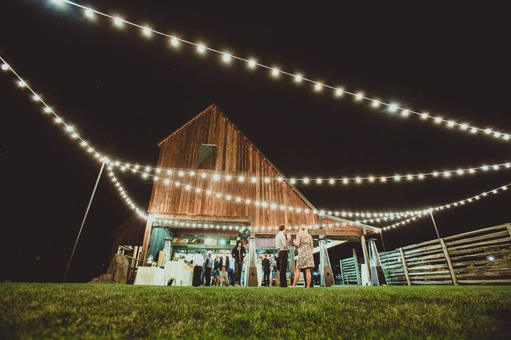 Lights were strung above the reception space outside of the barn at  Brasada Ranch.