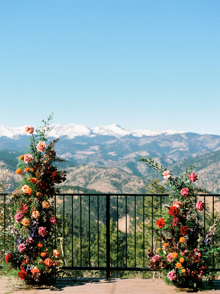 Floral arrangements frame this breathtaking mountain view.