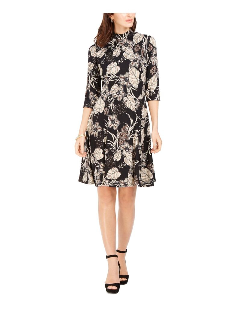 Model wearing a sheath dress with autumnal floral patterns