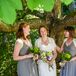 Liz's 'maids wore gray frocks from J.Crew, with added handmade ivory shrugs. The ladies held smaller green arrangements of button mums and hydrangeas.