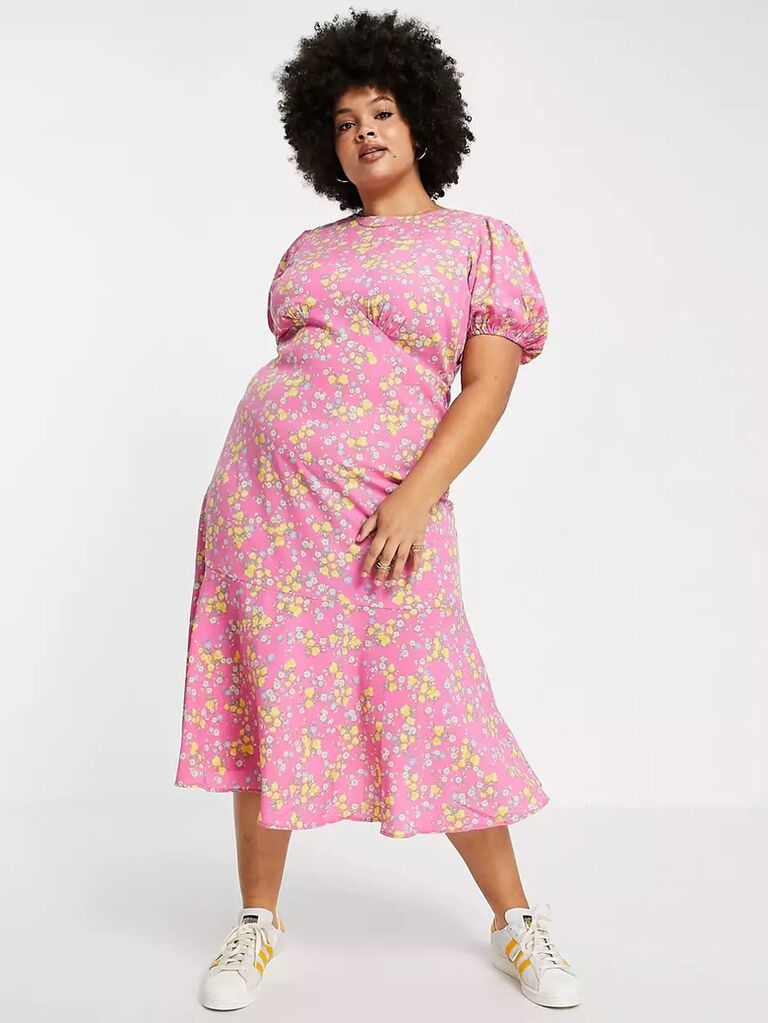 asos pink pastel dress for wedding guests with yellow and light blue floral print flowy skirt and short puffy sleeves