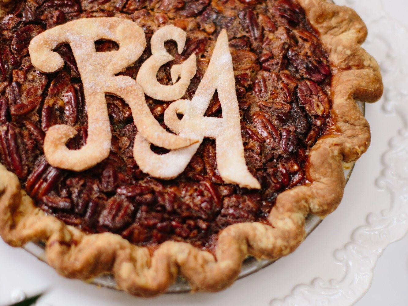 Pecan pie featuring couple's initials as decoration. 