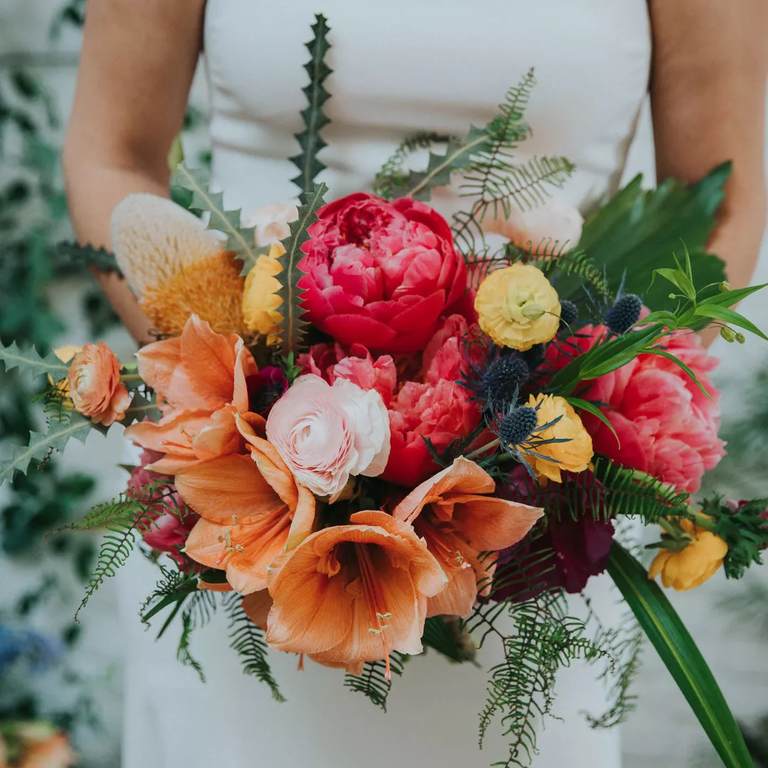 Protea, lily and rose wedding bouquet in summer tones
