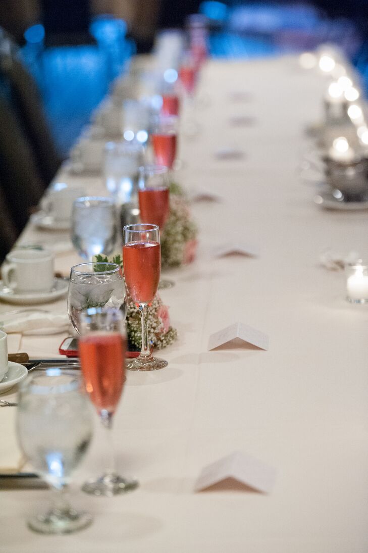 The wedding party at the head table was served pink champagne.