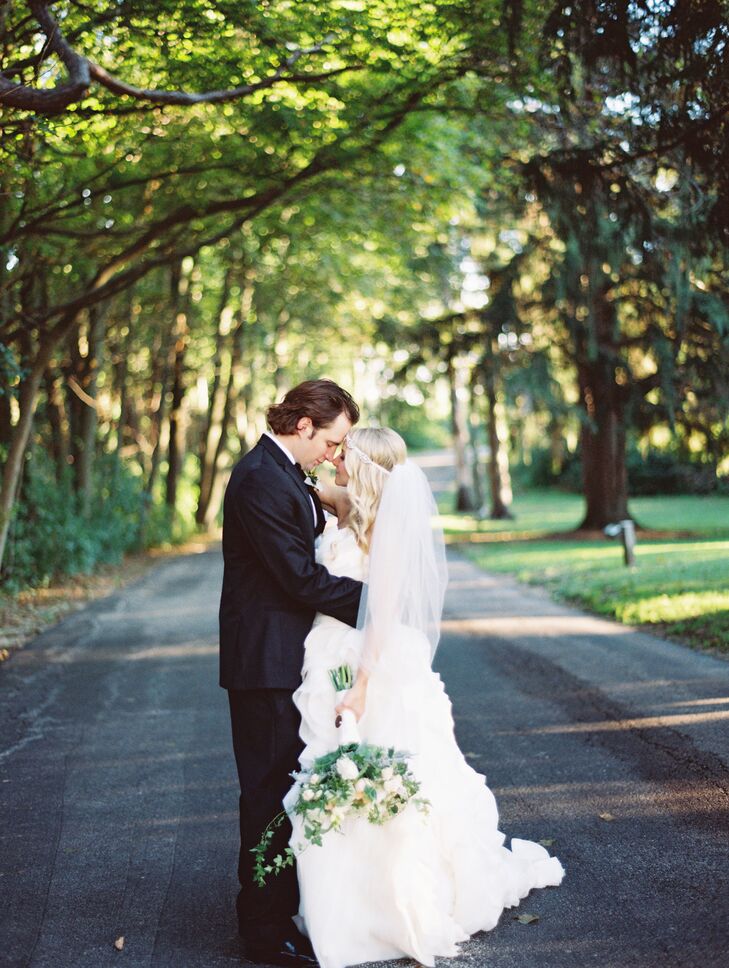 “My wedding dress was the first dress I tried on,” says Alex. The bride felt balanced between the fitted bodice and flowy, ruffled skirt. “It brought my dream of elegant fashion mixed with garden princess to real life.”