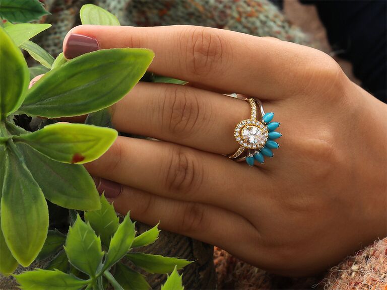 Seven marquise cut turquoise stones framing oval diamond halo ring on gold band