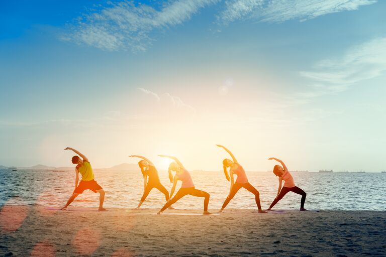 wedding fitness wellness tips yoga on the beach group