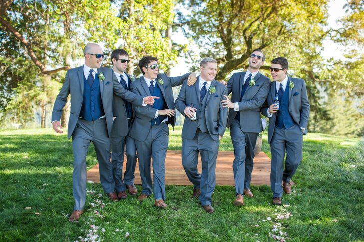 To complement the bridesmaid's navy dresses, the groomsmen donned classic gray suits with vests and ties in a similar shade of blue.