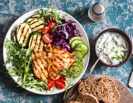Mediterranean diet salad and bread on a blue background