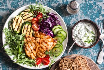 Mediterranean diet salad and bread on a blue background