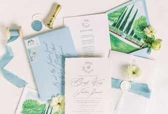 White wedding invitations with blue envelopes and white wax seals