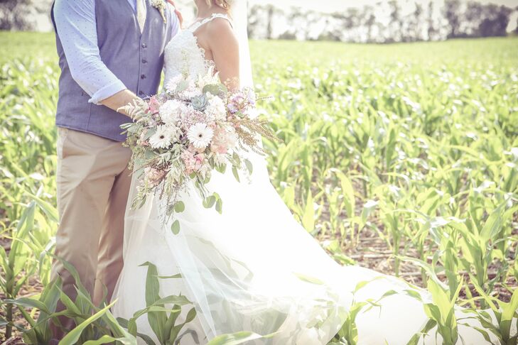 Shira carried a large bouquet of succulents, seeded eucalyptus, carnations, lisianthus, roses, and astilbes.